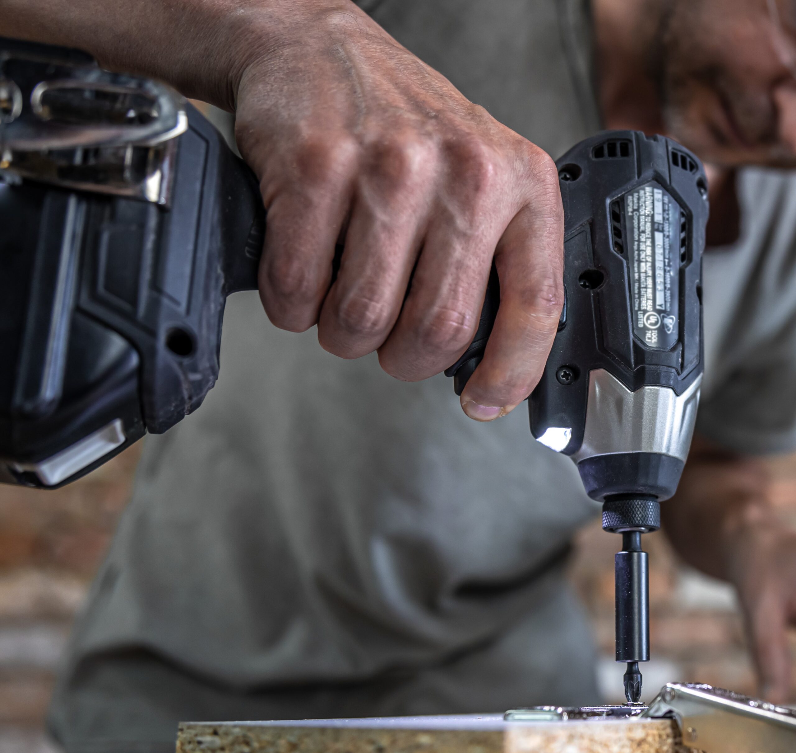 screwing-self-tapping-screw-into-metal-fastening-hole-wood-strip-using-screwdriver-work-carpenter screwing-self-tapping-screw-into-metal-fastening-hole-wood-strip-using-screwdriver-work-carpenter